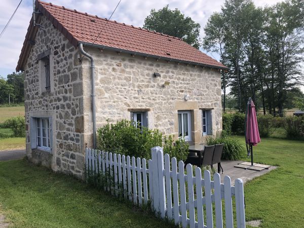 Terrasse plein sud en bois avec barbecue et salon de jardin